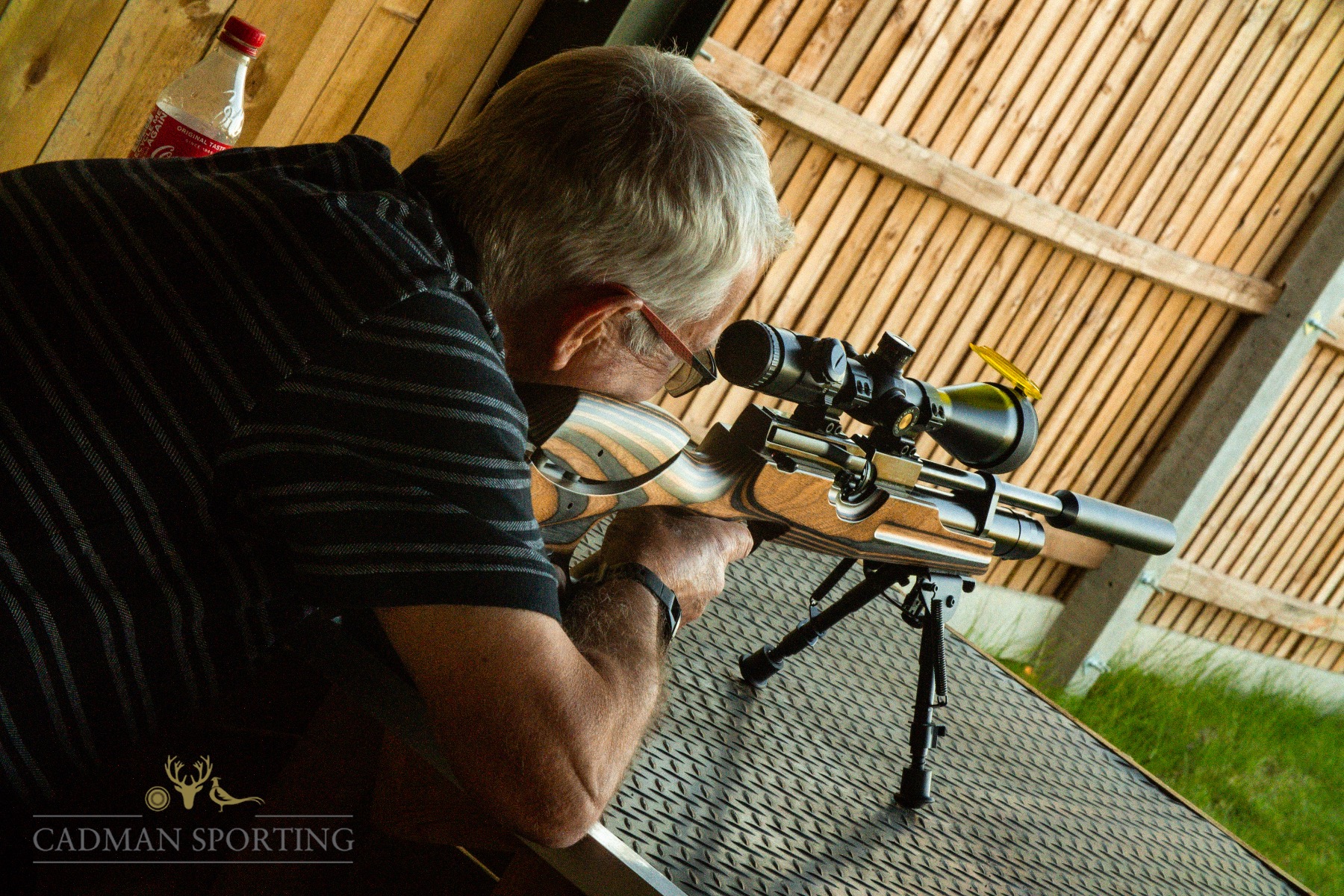 A Man Looking Down The Scope Of A Rifle