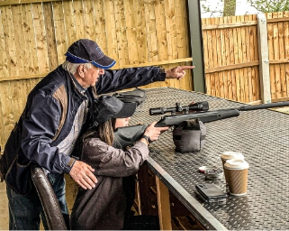 Man Showing A Lady Where To Aim